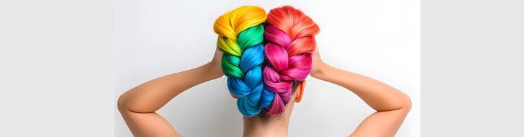 Back view of a woman with brightly coloured rainbow braids.